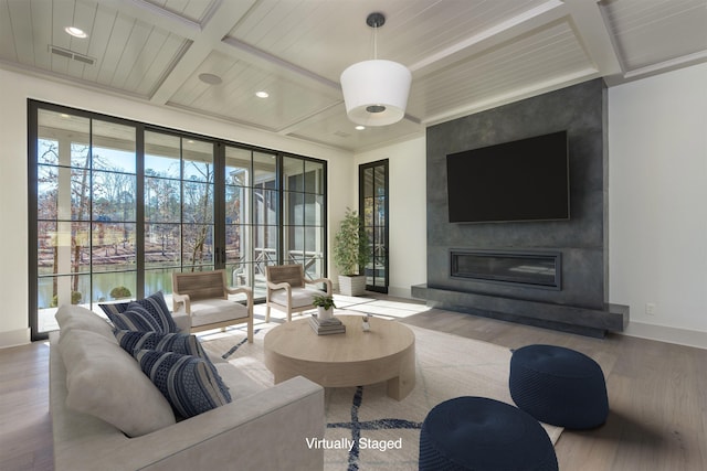 living room with a large fireplace, wood-type flooring, coffered ceiling, and beam ceiling