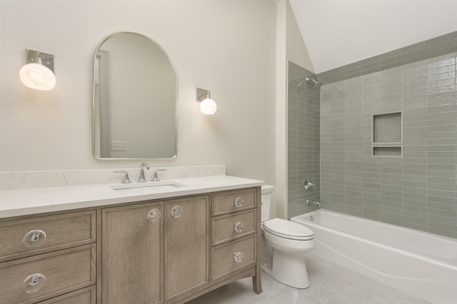 full bathroom with tiled shower / bath, vanity, toilet, and tile patterned floors