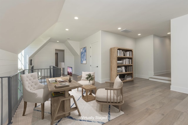 sitting room with vaulted ceiling and light hardwood / wood-style flooring