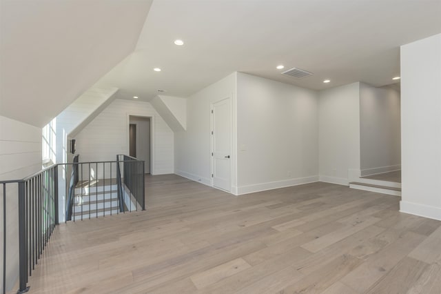 additional living space featuring light hardwood / wood-style flooring