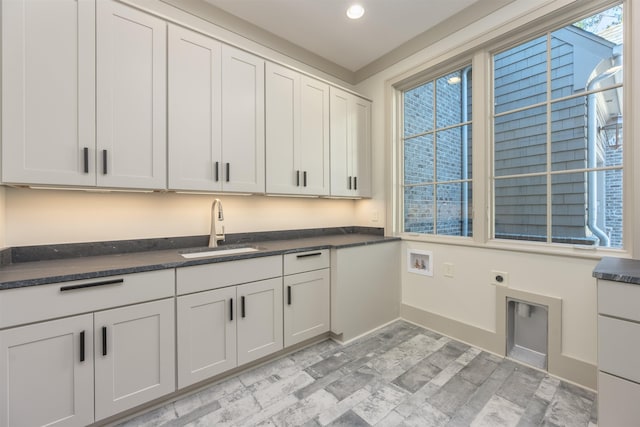 washroom with washer hookup, sink, cabinets, and electric dryer hookup