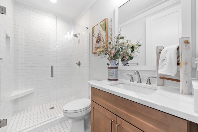 bathroom with a shower stall, toilet, and vanity