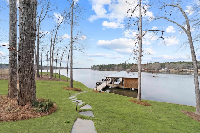 view of dock featuring a water view and a yard