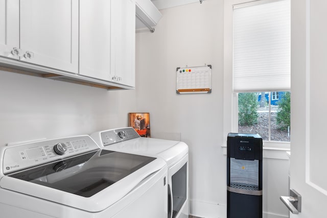 clothes washing area with cabinet space and independent washer and dryer