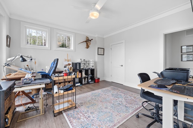 office area featuring a ceiling fan, crown molding, baseboards, and wood finished floors