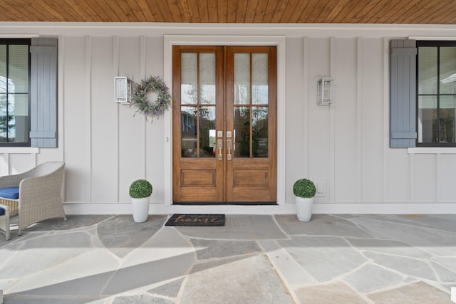 entrance to property featuring french doors and board and batten siding