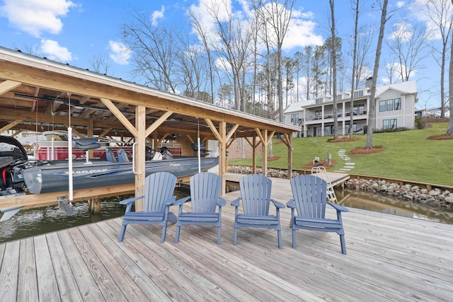 dock area with a water view and a yard