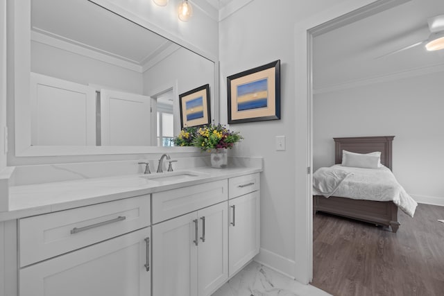 bathroom with marble finish floor, ornamental molding, vanity, ensuite bath, and baseboards