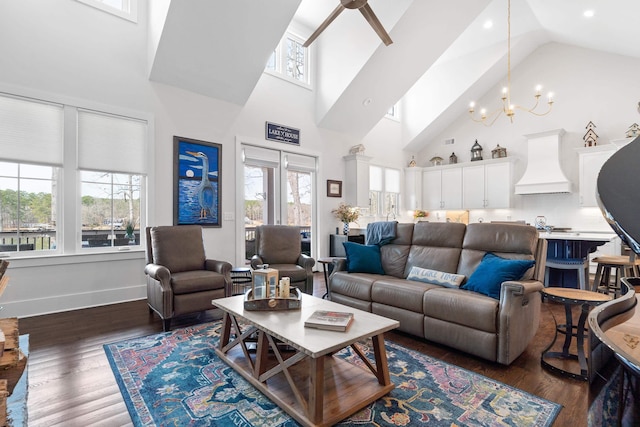 living area with baseboards, dark wood-style floors, high vaulted ceiling, a notable chandelier, and recessed lighting