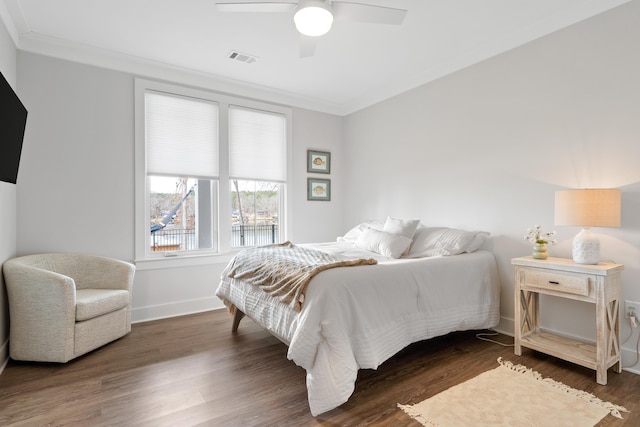 bedroom featuring a ceiling fan, baseboards, visible vents, dark wood-style floors, and crown molding