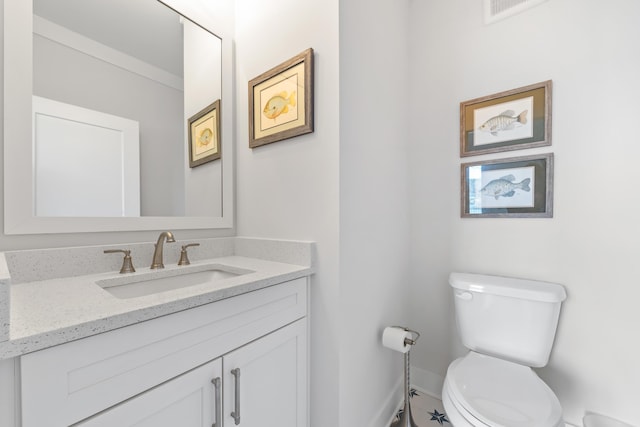 half bathroom with visible vents, vanity, and toilet