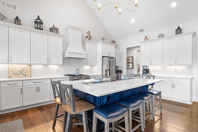 kitchen featuring premium range hood, white cabinetry, light countertops, and stainless steel appliances