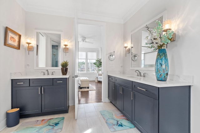 full bathroom featuring crown molding, two vanities, and a sink