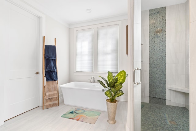 bathroom with a stall shower and a freestanding tub