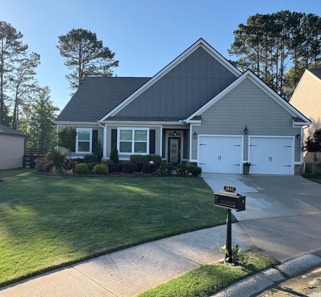 1041 Creekwood Cir, Madison, GA 30650 - craftsman house with board and batten siding, concrete driveway, an attached garage, a front yard, and roof with shingles