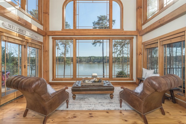 sunroom featuring a water view and a healthy amount of sunlight