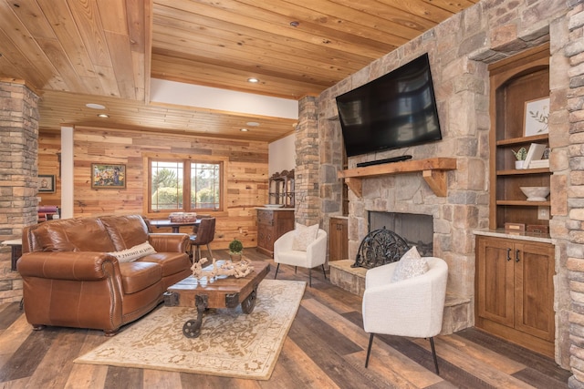 living area featuring a stone fireplace, dark wood finished floors, wood ceiling, and wooden walls