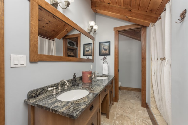 bathroom featuring lofted ceiling, wood ceiling, and a sink