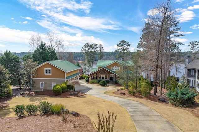 craftsman inspired home featuring metal roof and concrete driveway