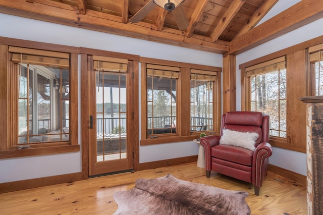 living area with vaulted ceiling with beams, wooden ceiling, baseboards, and light wood-style floors