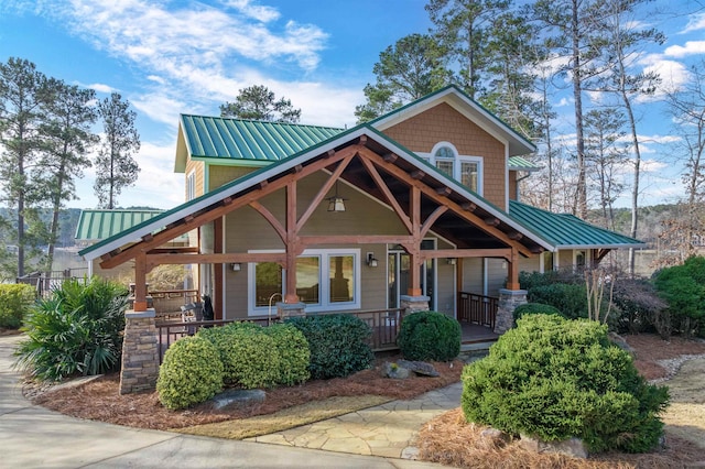 view of front of house with covered porch and metal roof