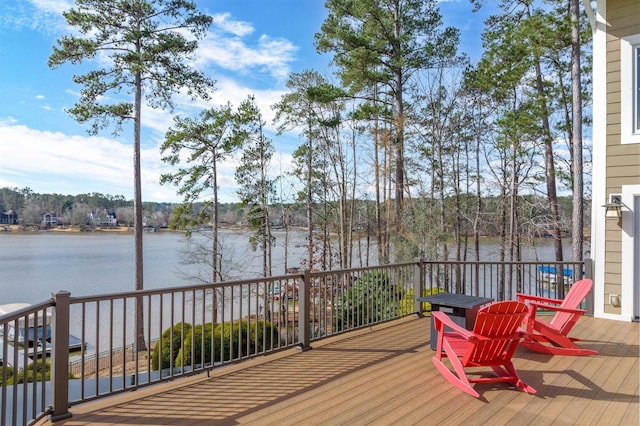 wooden terrace featuring a water view