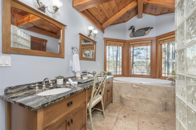 bathroom featuring lofted ceiling with beams, stone finish floor, vanity, wooden ceiling, and a bath