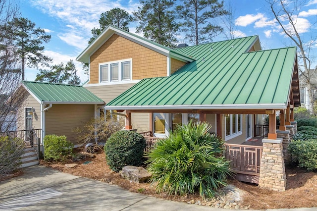 view of front of house featuring metal roof, a porch, and a standing seam roof