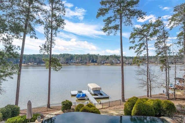 water view featuring a boat dock and fence