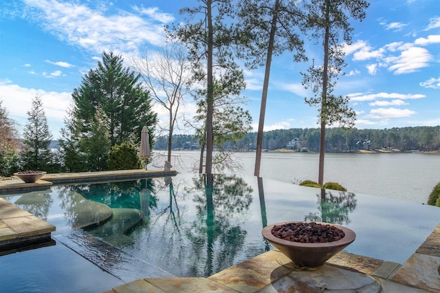 view of pool with a water view