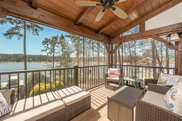 deck with a ceiling fan, a water view, and outdoor lounge area