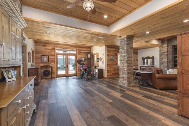 interior space with dark wood-style floors, wood ceiling, french doors, and ornate columns