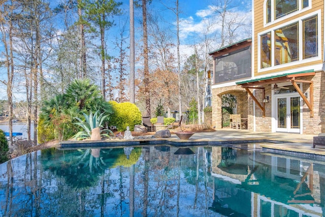 pool featuring french doors, a patio area, and ceiling fan