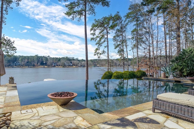 view of pool with a water view