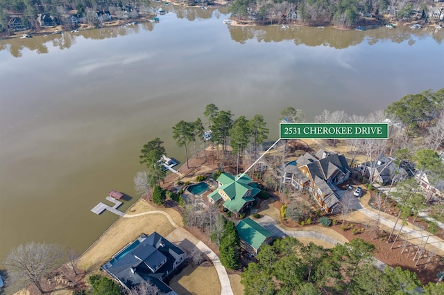 birds eye view of property with a water view