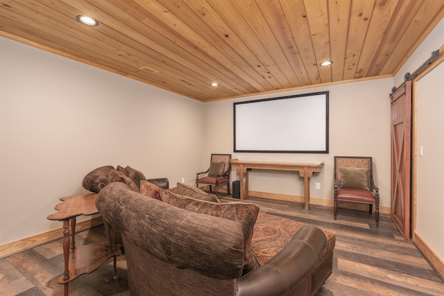 cinema room featuring a barn door, baseboards, dark wood finished floors, wooden ceiling, and recessed lighting