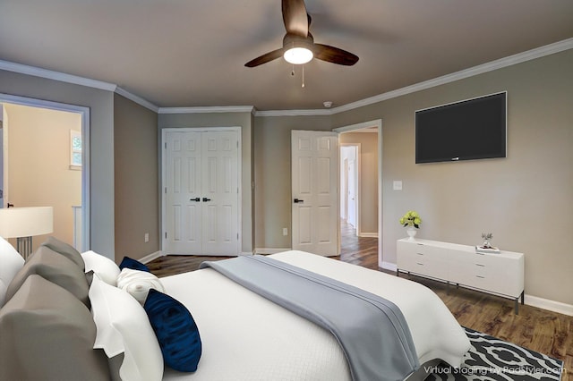 bedroom with dark hardwood / wood-style flooring, ornamental molding, and a closet