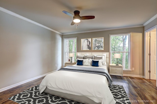 bedroom featuring crown molding, ceiling fan, dark hardwood / wood-style flooring, and multiple windows