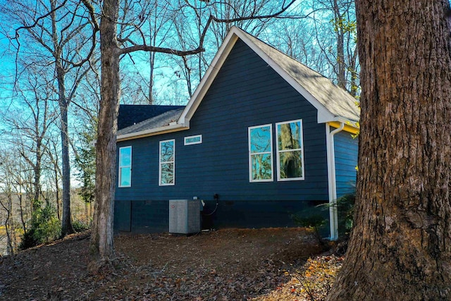 view of side of home featuring central AC unit