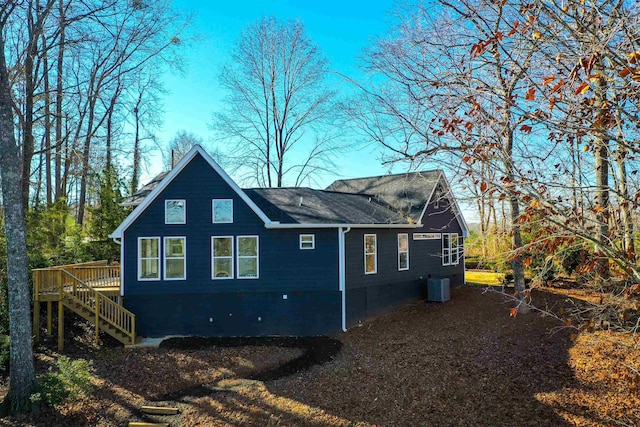 rear view of property with central AC unit and a deck