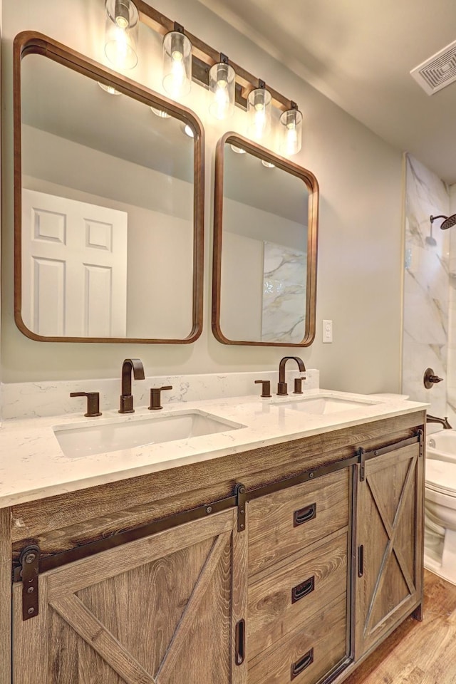 full bathroom featuring vanity, hardwood / wood-style floors, shower / bathing tub combination, and toilet