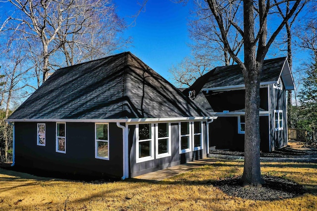 rear view of house featuring a lawn