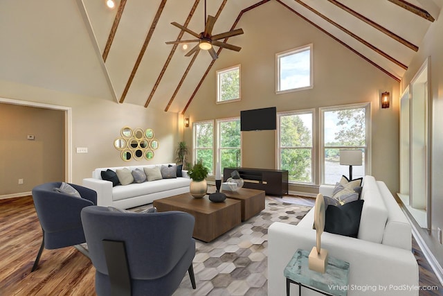 living room featuring light hardwood / wood-style flooring, high vaulted ceiling, and ceiling fan