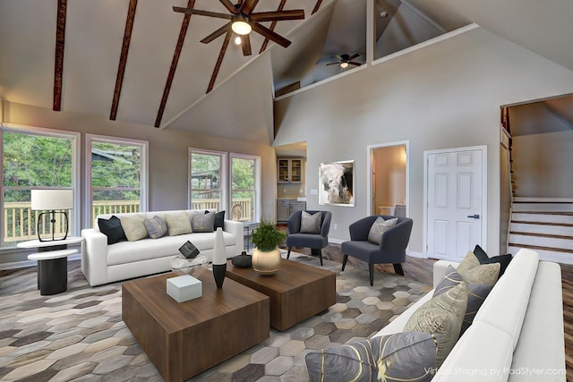 living room featuring ceiling fan and high vaulted ceiling