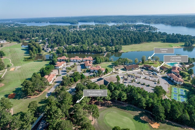 bird's eye view with a water view, view of golf course, and a wooded view