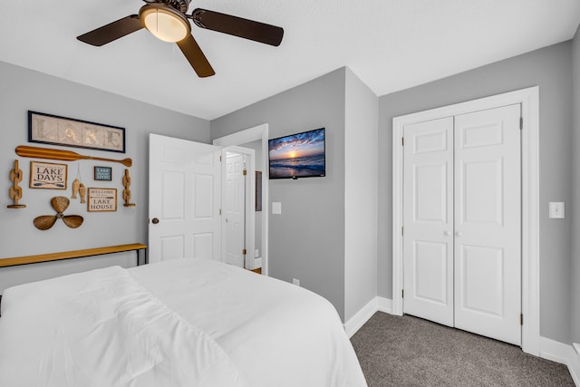 bedroom with ceiling fan, carpet floors, and a closet