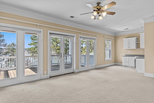 doorway with light carpet, french doors, ornamental molding, and visible vents