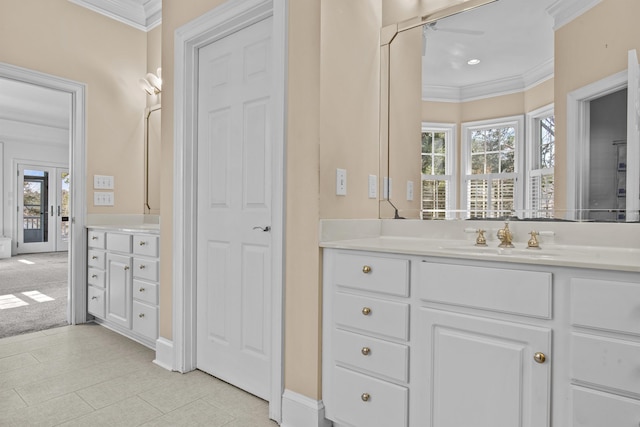 full bathroom with baseboards, french doors, crown molding, and vanity