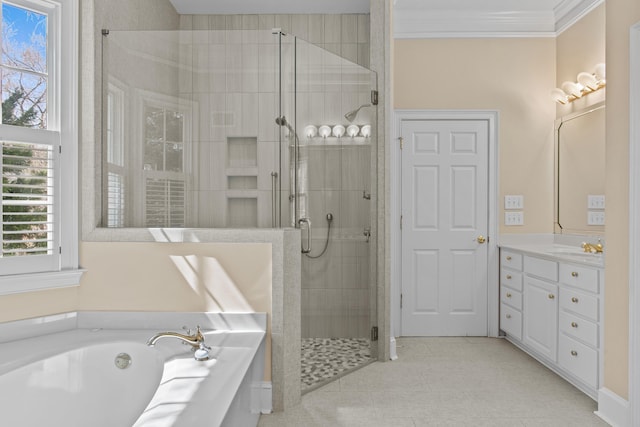 bathroom featuring a stall shower, ornamental molding, a garden tub, and vanity