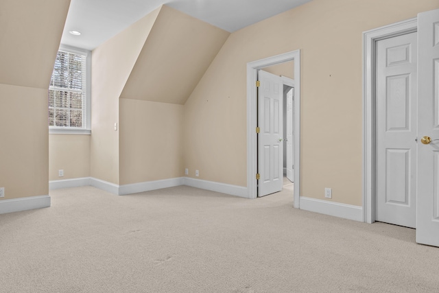 bonus room with carpet, baseboards, and vaulted ceiling